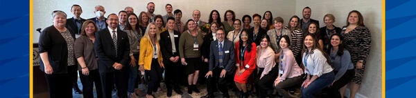 Nearly 40 staff members of UCR's University Advancement division pose with Chancellor Kim Wilcox at the CASE Regional Conference in San Diego in February 2022.